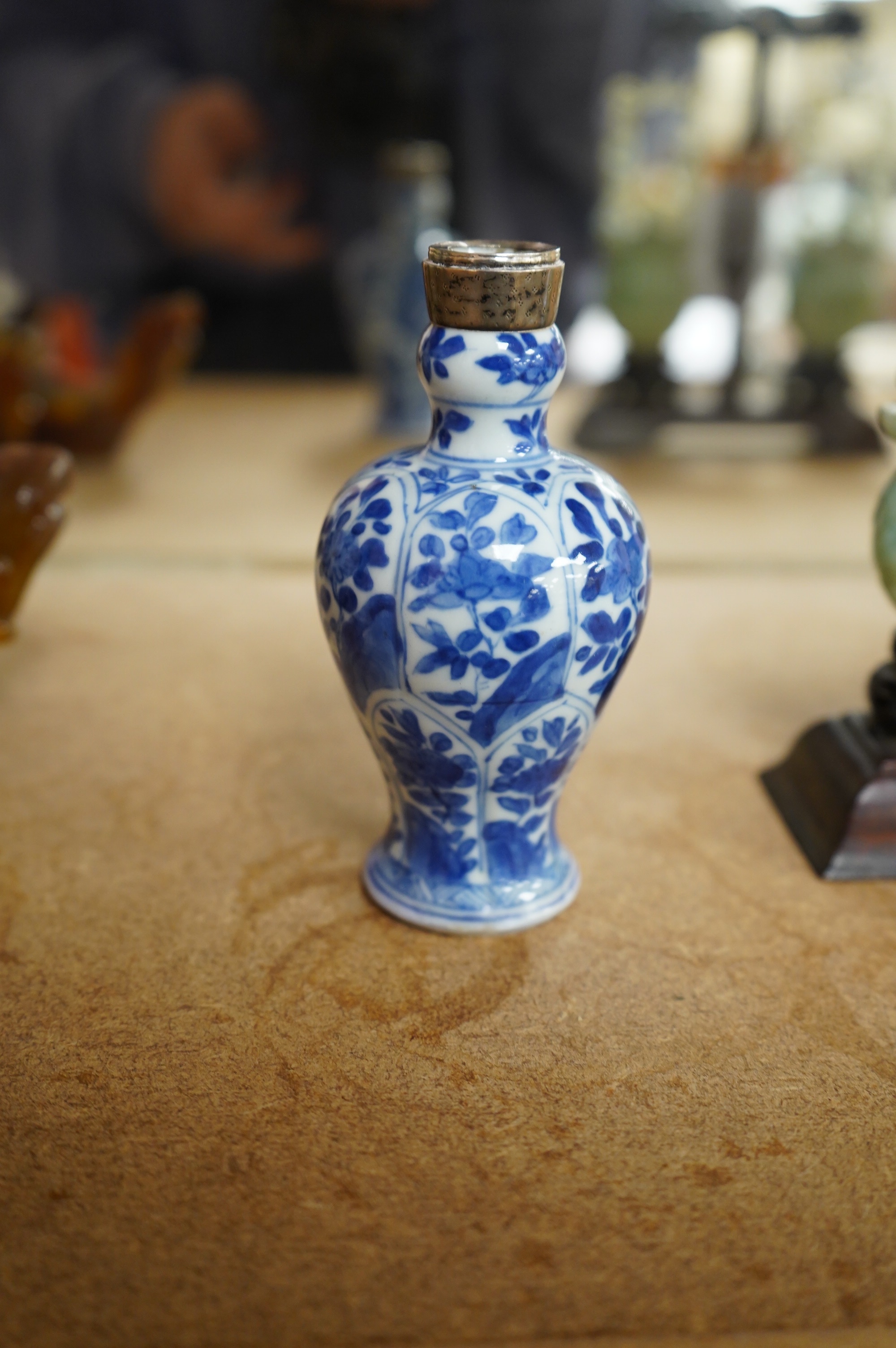 A Chinese small blue and white, white metal mounted vase, Kangxi, 12cm. Condition - poor to fair